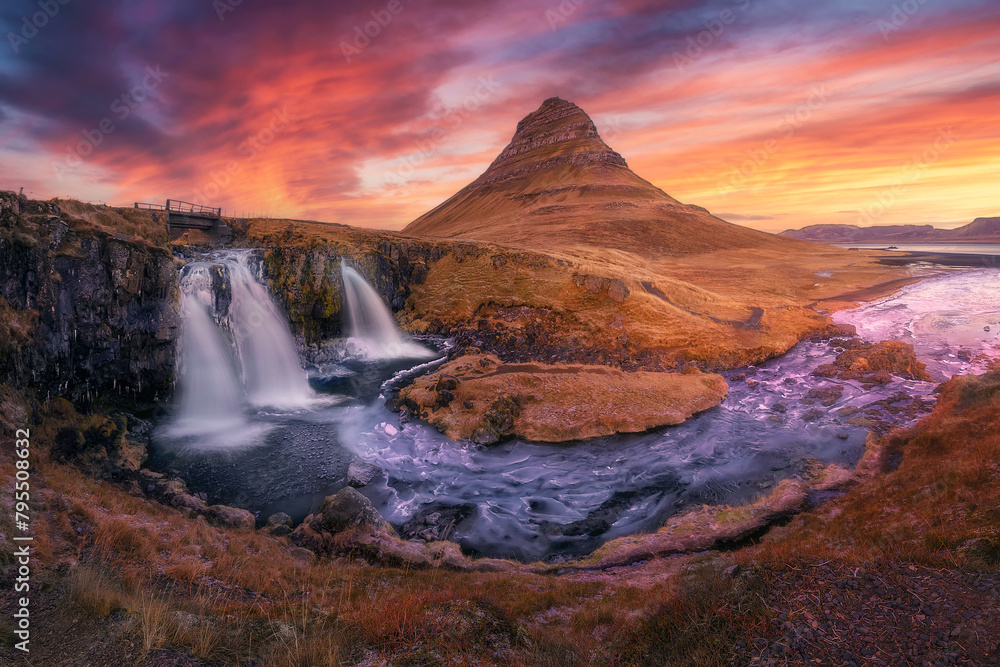 Colourful panorama of Kirkjufell mountain and Kirkjufellsfoss waterfall at sunset in Snaefellsnes National Park near Grundarfjördur (Grundarfjordur) in West Iceland