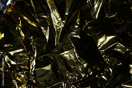 close up of crumpled golden black and silver paper, background, sstk  backgrounds