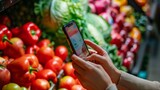 Person Using Cell Phone in Front of Vegetable Display