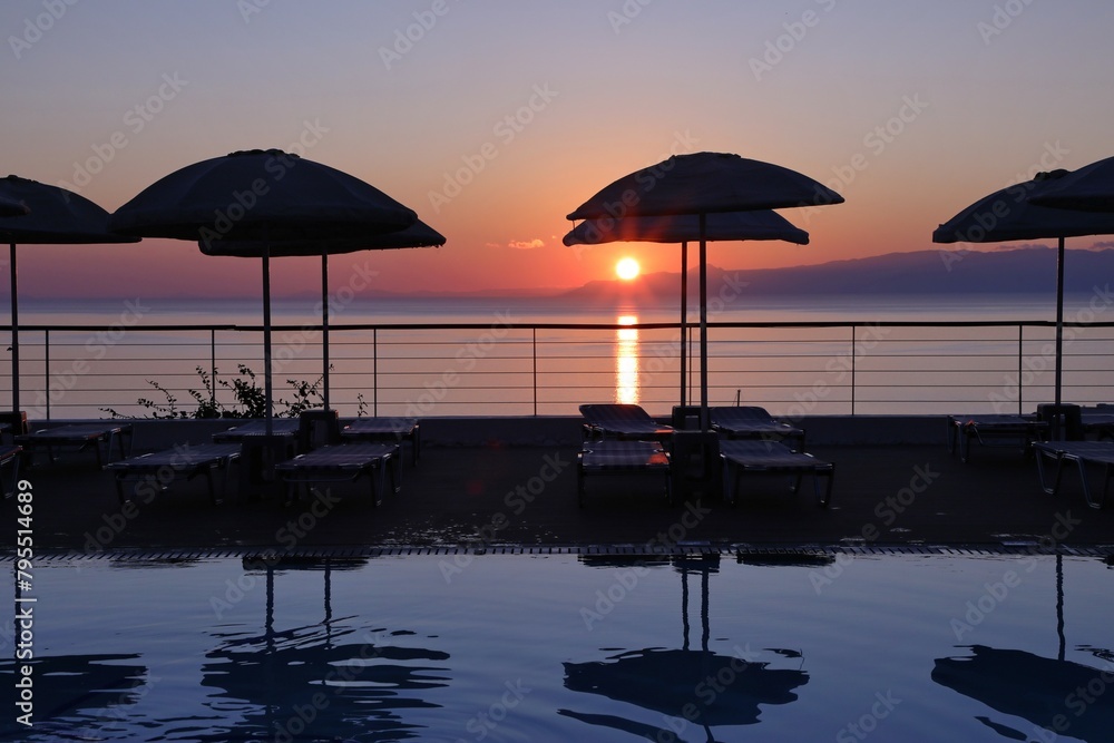 Fabulous sunrise by the sea by the pool early in the morning in Elounda on the island of Crete.