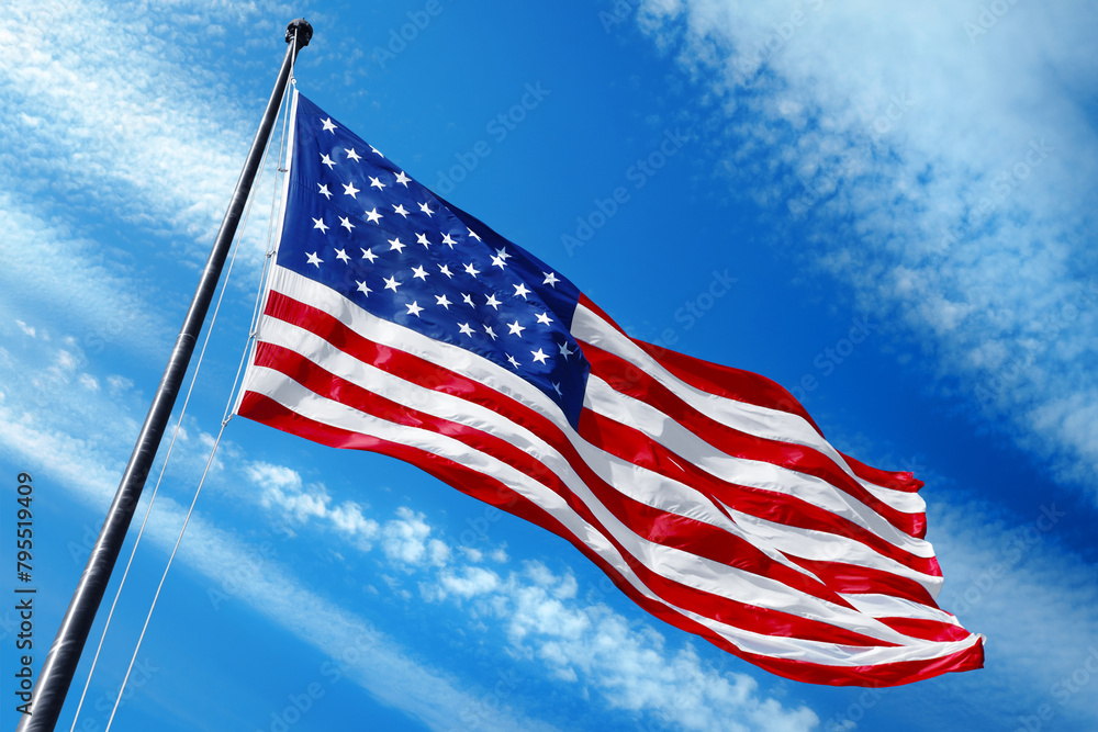 American flag on blue sky with beautiful clouds