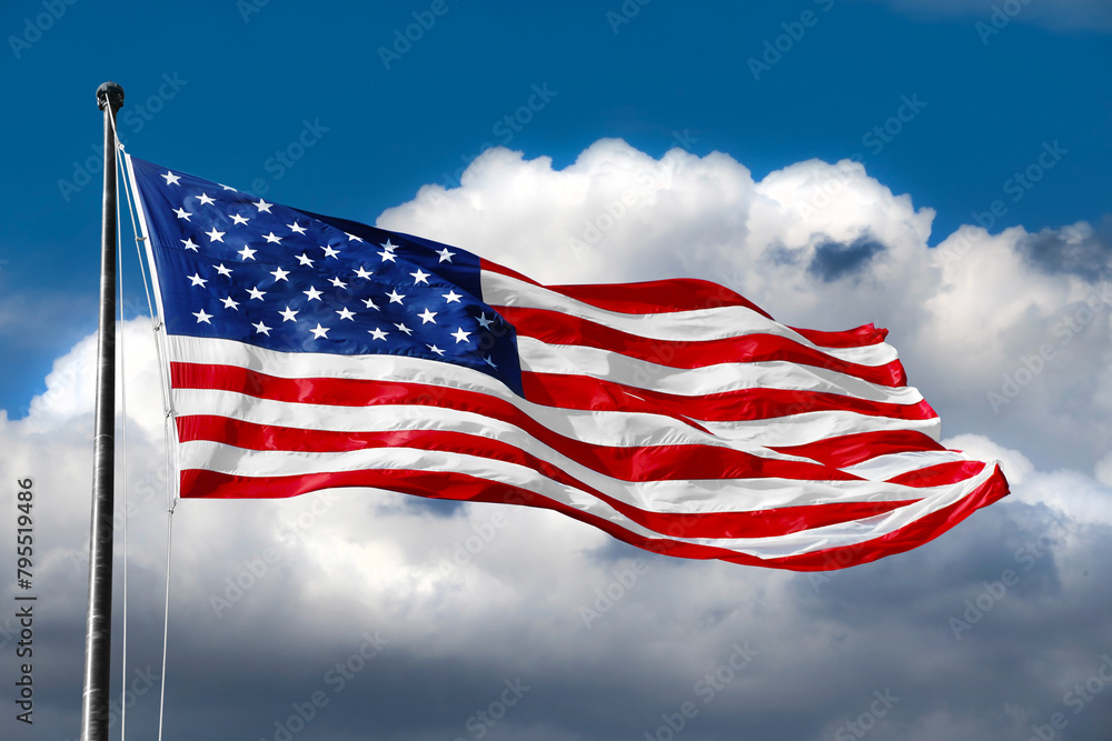Obraz premium American flag on blue sky with beautiful clouds