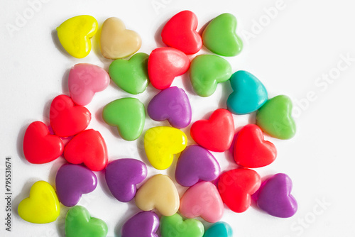 Multi-colored plastic hearts on a white background. Background for Valentine's day