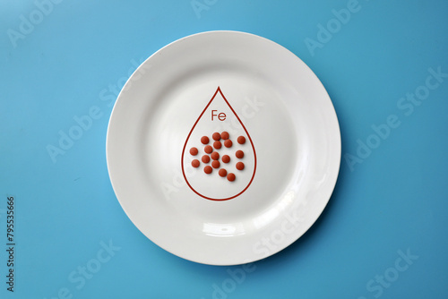 The mineral "iron" in tablets on a white plate. Iron deficiency in the body