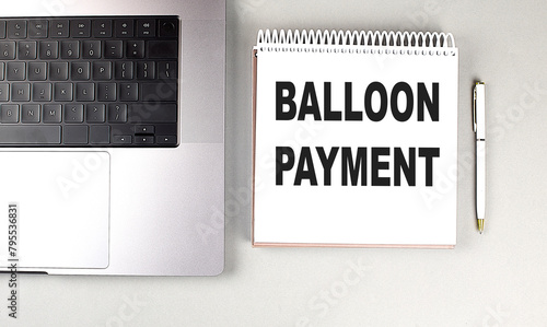 BALLOON PAYMENT text on notebook with laptop and pen