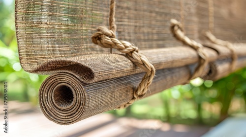   A tight shot of a wooden bench with a roll of fabric dangling from its seat behind photo
