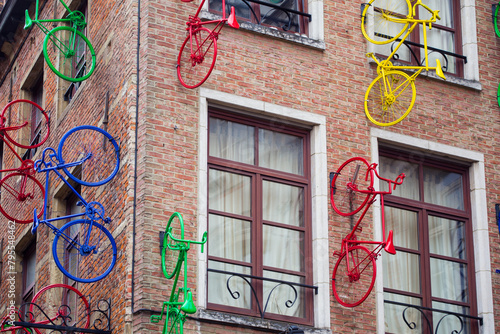 Closeup of a building facade decorated with colorful bikes, Brussels, Belgium