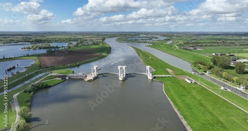 Maurik hydroelectric power station. Kaplan turbine for electricity generation in typical dutch landscape at springtime. Sustainable energy, clean green energy. Aerial drone view. photo