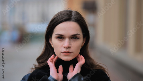 Sensitive portrait of a brunette girl on a cloudy spring day