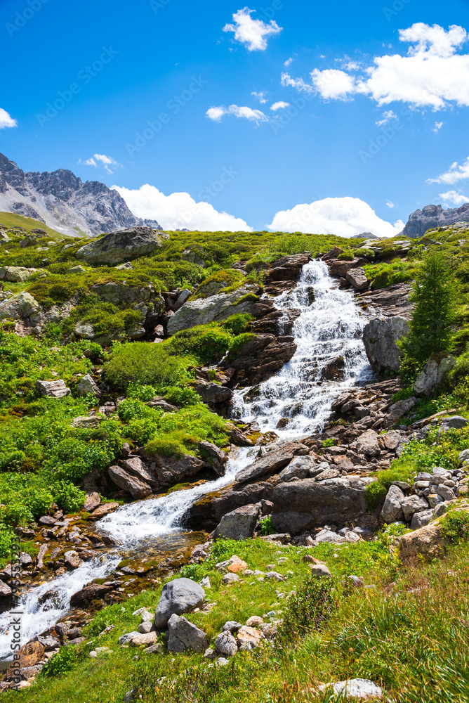 Water stream in French Alps. Peisey valley, Savoie, France. Beautiful nature mountain valley landscape background. Earth beauty, eco-planet, environment and ecology concepts.