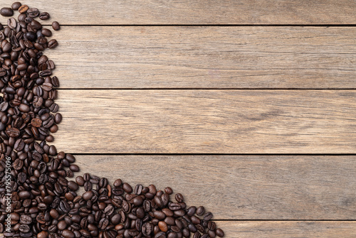 Closeup of coffee beans over rustic wooden table with copy space