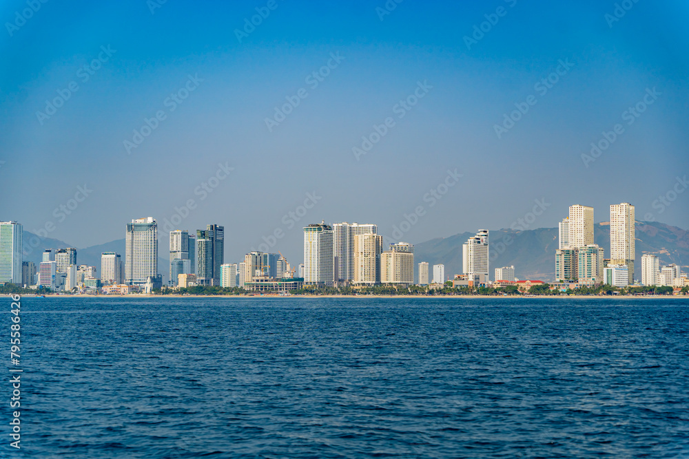 The city is from a distance from the sea.
Nha Trang city in Vietnam. View of the city from the sea. The city is from a distance from the sea.
Nha Trang city in Vietnam. View of the city from the sea.