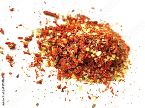 Colorful dried tomato flakes on a bright background.