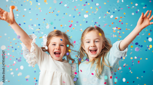 Cheerful two little girl celebrating birthday with glittery confetti splashing. Children birthday party. Celebrating New Year