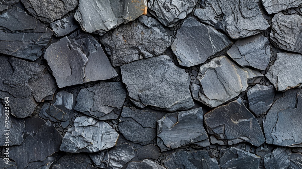 A tight shot of a black and gray rock wall texture A tight shot of a black and gray rock wall texture