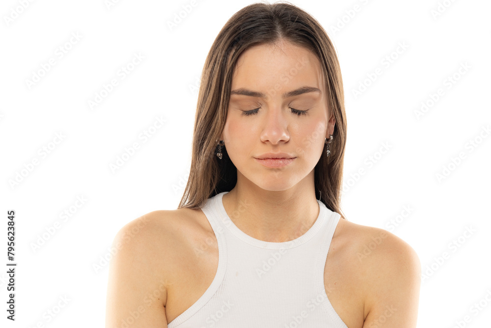 portrait of a young teenage girl with closed eyes on a white background portrait of a young teenage girl with closed eyes on a white background