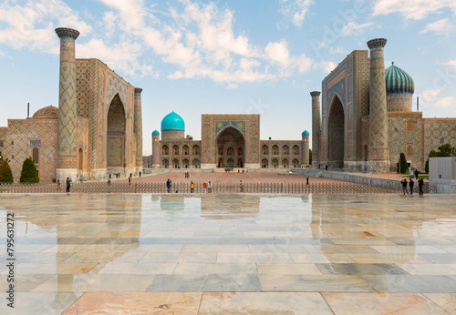 Awesome view of the Registan Square in Samarkand, Uzbekistan. The Ulugh Beg Madrasah and the Sher-Dor Madrasah reflected in wet floor. The Registan is a popular tourist attraction of Central Asia.