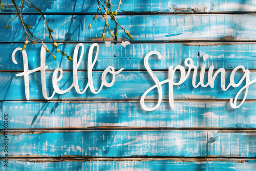 "Hello Spring" written on cyan wooden board