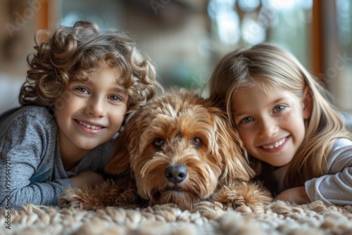 A curly-haired boy and a girl share a moment with a cuddly dog on a carpet
