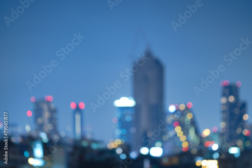 Abstract blurred background cityscape of Krung Thep Maha Nakhon (Bangkok) on night scene with multicolour bokeh from neon light on building © chiradech