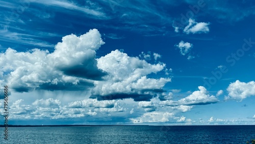 View of the sea and blue sky with white clouds. Summer photo landscape.