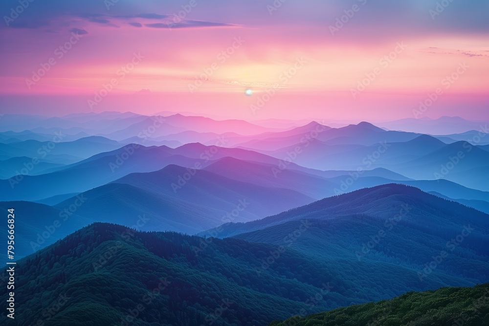Sunset over layers of blue mountain ranges