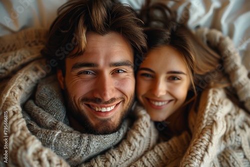 High-definition close-up of a smiling couple wrapped in a chunky yarn blanket