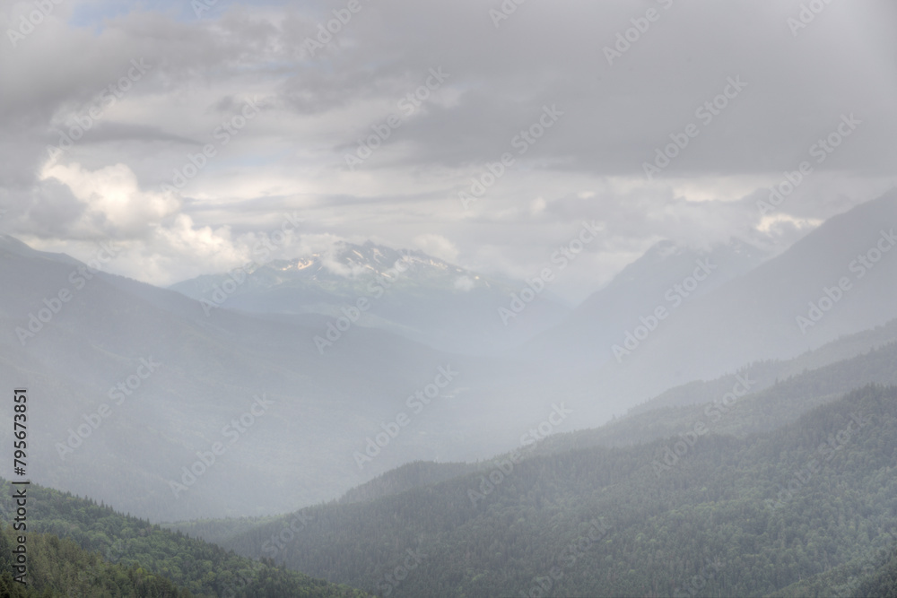 Naklejka premium Foggy landscape. Mountains in a foggy haze.