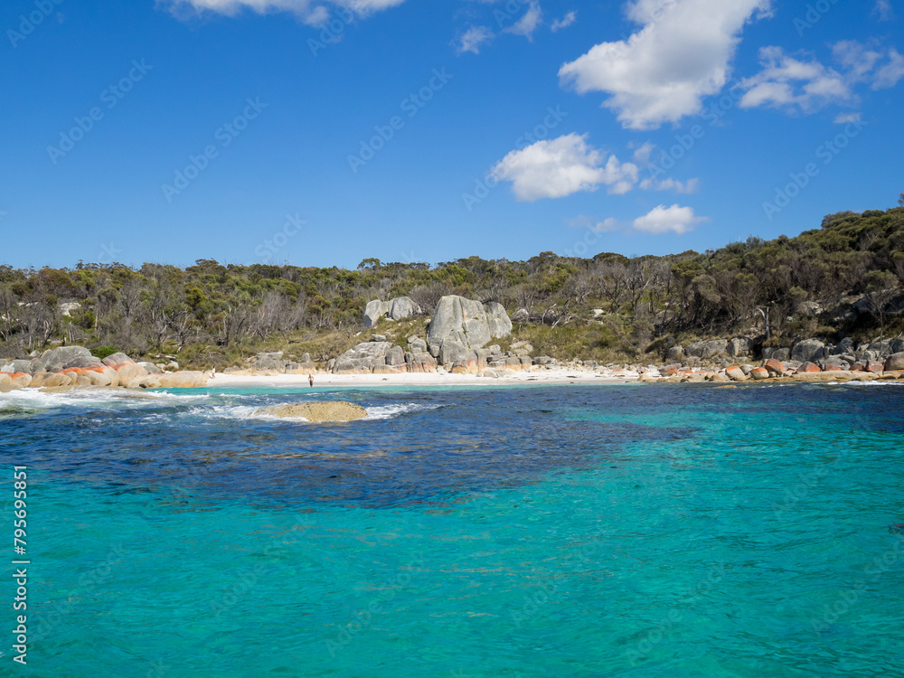 Turquoise waters, red lichen covered rocks and bush of the Bay of Fires, Tasmania