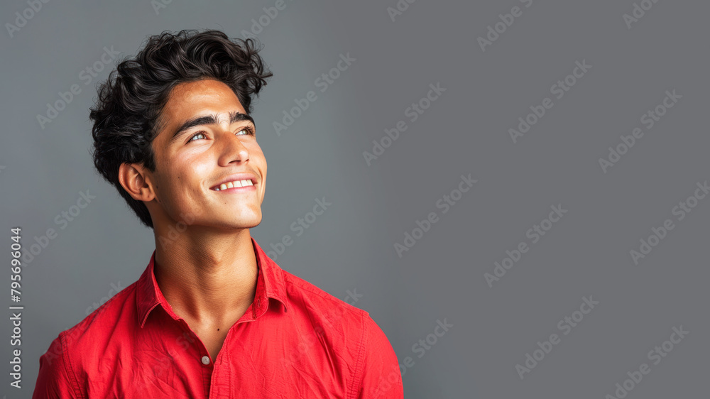 Side view candid of hispanic businessman in red shirt smiling isolated Side view candid of hispanic businessman in red shirt smiling isolated