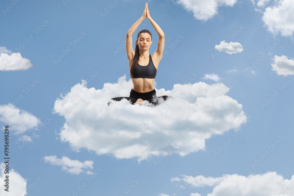 Young woman exercising yoga on a cloud Young woman exercising yoga on a cloud