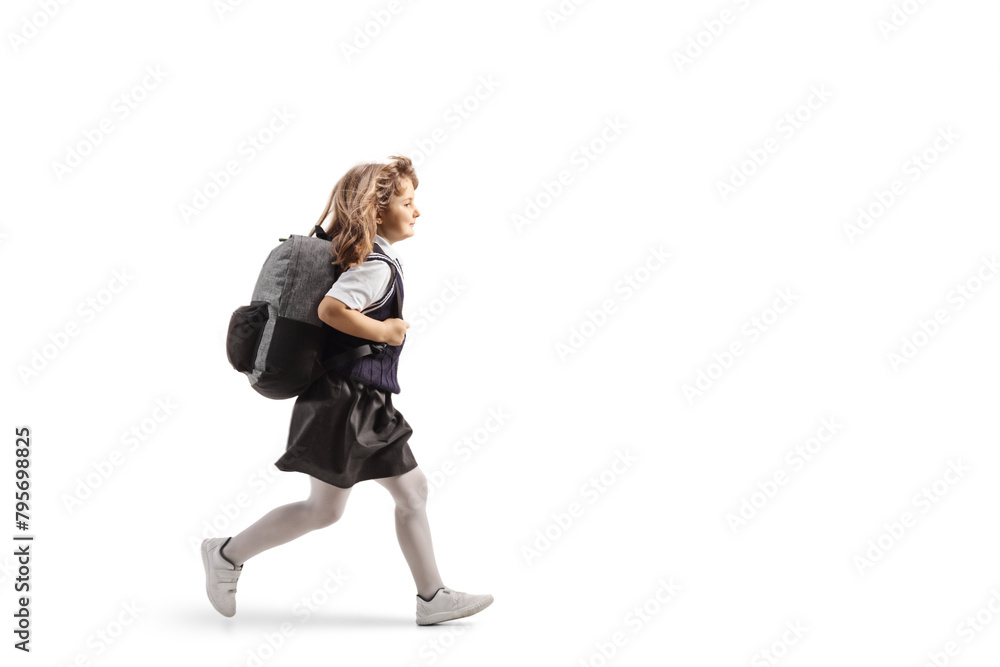 Full length profile shot of a schoolgirl in a uniform carrying a backpack and running