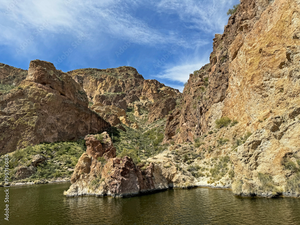 View from a steamboat, of Canyon Lake reservoir and rock formations in Maricopa County, Arizona in the Superstition Wilderness of Tonto National Forest near Apache Trail. The lake was formed by dammi View from a steamboat, of Canyon Lake reservoir and rock formations in Maricopa County, Arizona in the Superstition Wilderness of Tonto National Forest near Apache Trail. The lake was formed by dammi