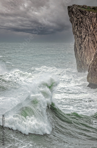 DANGEROUS WAVE APPROACHING TO HIT THE CLIFF IN THE CANTABRIC SEA photo