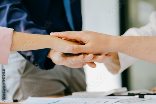 Group of businesspeople busies discussing financial Business people brainstorming at office desk, they are analyzing financial reports and pointing out financial data on a sheet