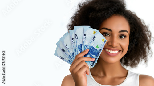 Young black woman holding and showing 1000 Nigerian naira notes to camera over white background with copy space, African lady happy similing, hand holds money cash, naira currency	 photo