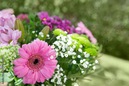 Colorful mixed flowers bouquet isolated on blur green background. © Swetlana Wall