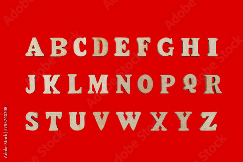 wooden letters of the English alphabet on a red background