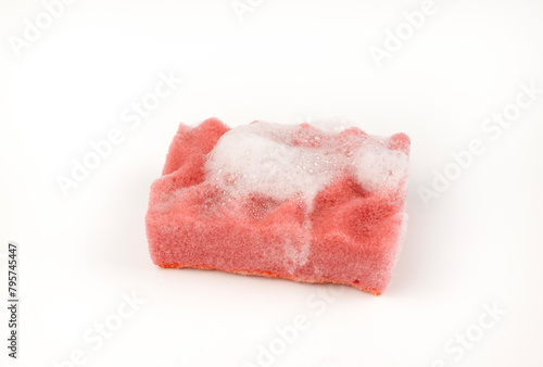 A sponge with soap suds isolated on a white background.