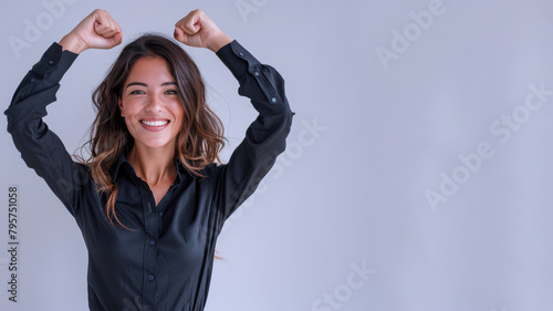 Hispanic businesswoman wearing black shirt, smiling and raised hands