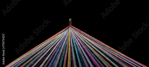 Rainbow Colored Threads Through Needle Eyelet on black background