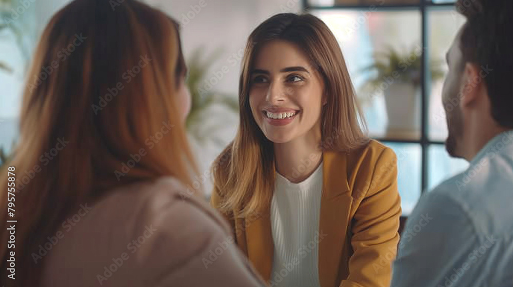 Young happy couple communicating with female real estate agent in office Young happy couple communicating with female real estate agent in office