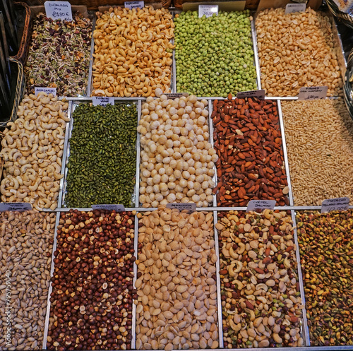A market stall in popular La Boqueria market in Barcelona, Spain displays a variety of nuts, beans, raw or dried, from plain to exotic.