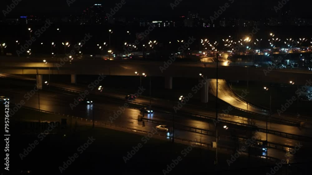 On night roads, cars drive over a bridge and a road junction. Urban cityscape concept or abstract of advanced innovation, financial technology, energy power. On night roads, cars drive over a bridge and a road junction. Urban cityscape concept or abstract of advanced innovation, financial technology, energy power.