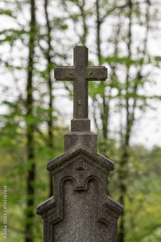 A stone cross on a grave without Jesus.