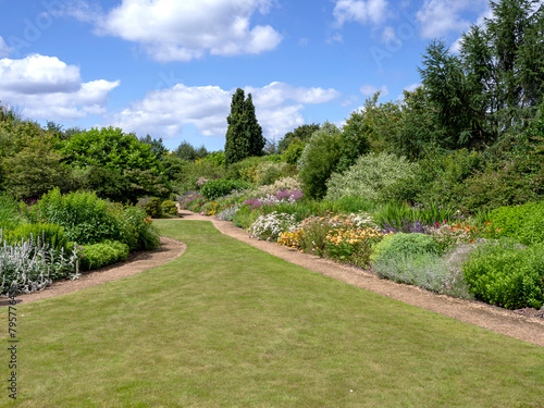 Fototapeta Naklejka Na Ścianę i Meble -  Summer garden with flower borders and a lawn