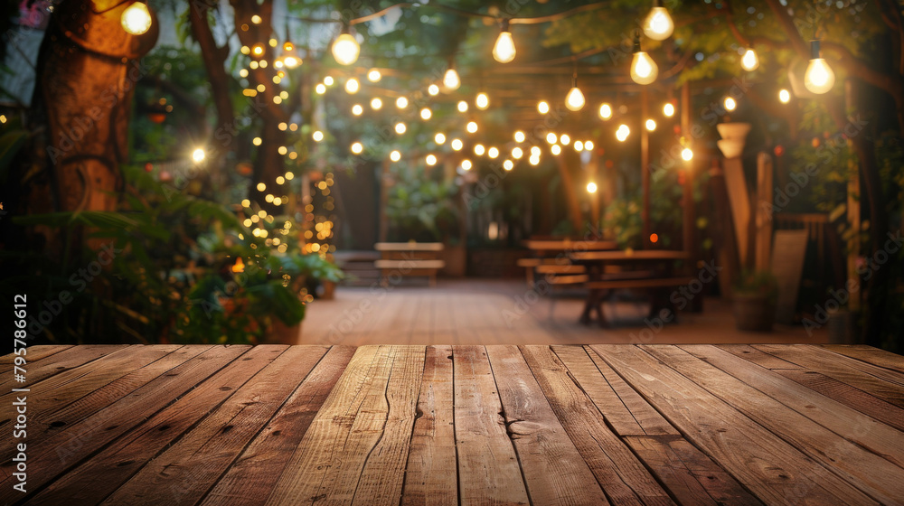 Rustic wooden table foreground with a magical garden and string lights in the background Rustic wooden table foreground with a magical garden and string lights in the background