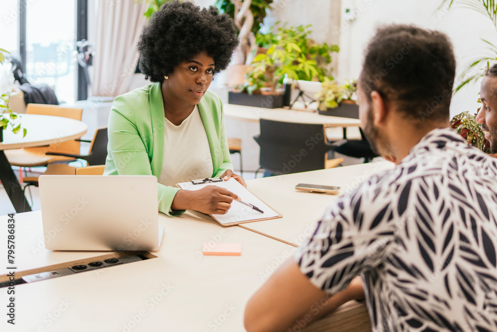 Professionals collaborating in a modern office setting Professionals collaborating in a modern office setting