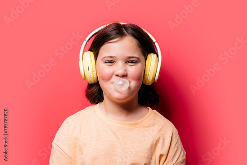 Girl with Headphones Blowing Bubble Gum in Studio photo