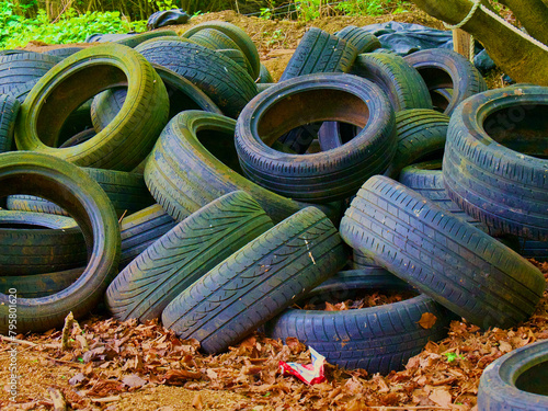 rubber tyres in a pile in the woods